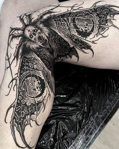 a woman's thigh with an intricate tattoo design on it