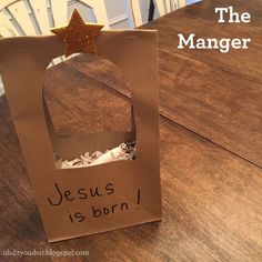 a paper bag with the word jesus is born written on it sitting on top of a wooden table