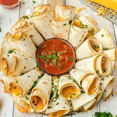 a platter filled with tortillas and salsa