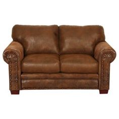 a brown leather couch sitting on top of a white floor