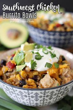 southwest chicken burrito bowls in a bowl with avocado and sour cream on top