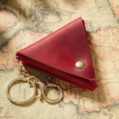 a red leather wallet and pair of scissors on a map