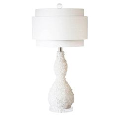 a white table lamp with a white shade on the base and a white fabric lampshade