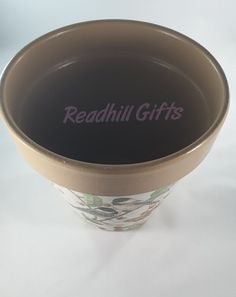 a brown bowl with the words readhill gifts written in purple ink on it's side