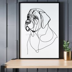 a black and white drawing of a dog's face on a wall next to a potted plant