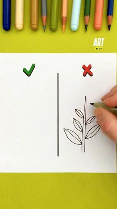 someone is drawing a plant on paper with crayons