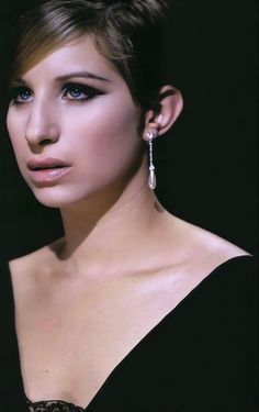 a woman with blue eyes and black dress