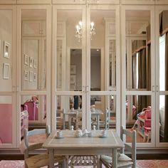 a dining room table with chairs and a chandelier