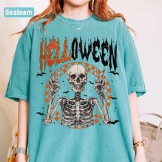 Halloween Shirt, Halloween 2024 Tshirt, Cute Fall Shirt, Women's Fall Shirt, Halloween Party Shirt, Family Halloween Matching Shirts Get into the Halloween spirit with our spooktacular Halloween T-shirt! Featuring a fun and festive design, this shirt is perfect for celebrating the season with style. Crafted for women, it's a versatile addition to your autumn wardrobe. Whether you're heading to a Halloween party or just enjoying the fall festivities, this tee is sure to make a bewitching statemen Halloween Blue Tops With Letter Print, Blue Halloween Top With Letter Print, Blue Halloween Tops With Letter Print, Blue Halloween Letter Print Tops, Blue Letter Print Top For Halloween, Blue Pre-shrunk Tops For Halloween, Halloween Skull Print Crew Neck Shirt, Halloween Skull Letter Print Tops, Grunge Crew Neck Shirt For Halloween