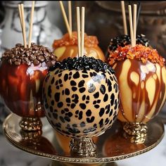 caramel apples with chocolate and sprinkles on a gold plate