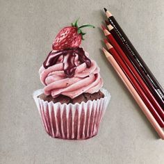 a drawing of a cupcake with pink frosting and a strawberry on top next to colored pencils