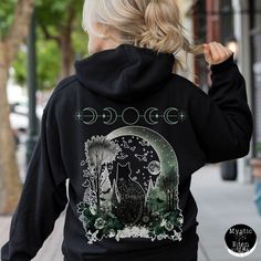 Introducing our enchanting Black Cat Hoodie - a whimsical fusion of witchy charm and Halloween allure that's perfect for those who embrace the mystical and magical! This captivating hoodie showcases an original watercolor art piece of a bewitching black cat with a tattoo-like design adorning its back, gazing out into the mesmerizing night sky. 🌙 Key Features: 🖤 Original Watercolor Art: Our exquisite hoodie features a unique, hand-painted illustration of a black cat, exuding an air of mysteriou Black Hooded Hoodie With Cat Print, Black Hoodie With Cat Print, Black Long Sleeve Hoodie With Cat Design, Black Hoodie With Cat Design, Whimsigoth Halloween, Witchy Shirt, Goblincore Aesthetic, Chat Halloween, Painted Illustration