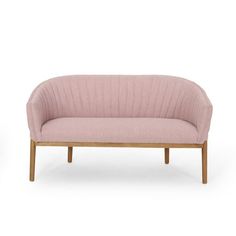 a pink couch sitting on top of a wooden frame