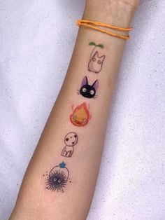 a woman's arm with tattoos on it and an orange string around the wrist