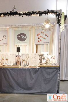 the table is set up with jewelry on it for display at an event or party