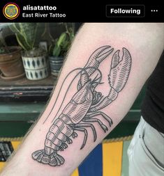 a black and white lobster tattoo on the left arm, it looks like he is ready to eat