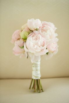 a bouquet of pink flowers sitting on top of a table