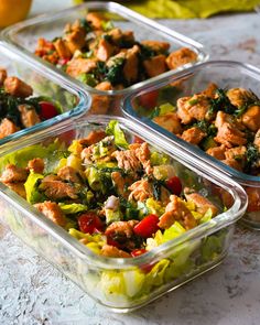 four plastic containers filled with food on top of a table