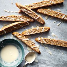 some bread sticks with icing and a cup of milk