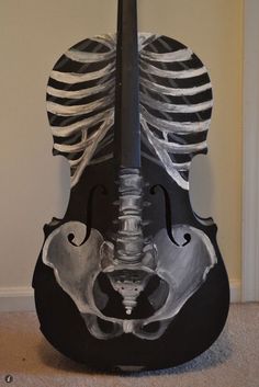 a violin that has been painted to look like a skeleton with its head turned upside down