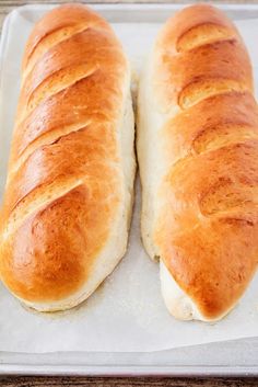 two loaves of bread sitting on top of a pan