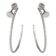 This is part of Chairish’s Fine Jewelry assortment.  Cartier Juste Un Clou Diamond Hoop Earring in 18K White Gold 1.26 CTW  PRIMARY DETAILS  SKU: 131692  Listing Title: Cartier Juste Un Clou Diamond Hoop Earring in 18K White Gold 1.26 CTW  Condition Description: Translating to 'just a nail', the Juste Un Clou collection from Cartier is one of the Maison's most celebrated styles. The collection was born in the '70s and represented the brand's edgier side and flair for unique design. Comes with th Luxury Silver Baguette Cut Hoop Earrings, Luxury Diamond Cut Platinum Hoop Earrings, Luxury Hoop Earrings With Bail, Luxury Silver Clip-on Hoop Earrings, Cartier Collection, Cartier Juste Un Clou, Luxury Hoop Earrings With Gold-tone Hardware, Cartier Earrings, Diamond Hoop Earrings