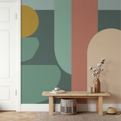 a living room with a table, vase and wallpaper on the walls in different colors