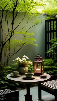 a table with two tea cups and a lantern on it