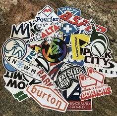 a pile of stickers sitting on top of a rock