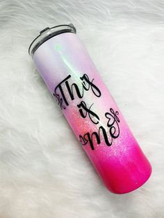 a pink and purple water bottle with writing on it that says, this is me