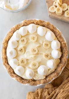 a pie with banana slices and cream on top