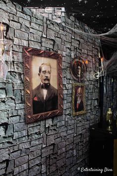 a stone wall with two framed pictures on it