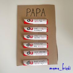 four white and red toothbrushes sitting on top of a cardboard box with the words papa written on it