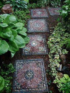 a garden path made out of stones and plants