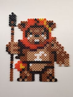 an image of a pixel art made out of legos on a white surface with a hammer in it's hand