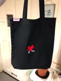 a black bag with a red heart on it