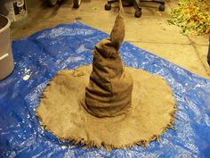 a sand wizard hat sitting on top of a blue tarp