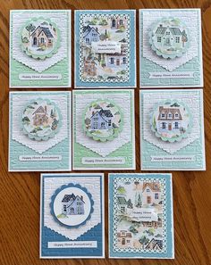 six cards with houses on them sitting on a table