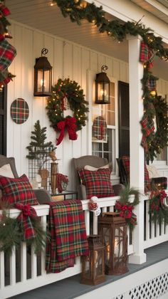 the front porch decorated for christmas with wreaths, lights and plaid blankets on it