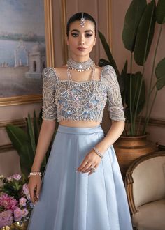 Ice Blue Pakistani Bridal Dress in Lehenga Choli Style is an elegant masterpiece that gives you a charismatic look on the big day. Motifs, pearls, and beaming adornments give a magnificent look to this beautiful Bridal Lehenga Choli, making it your priority for the wedding. Choli: Beautiful choli in an elegant ice blue shade is emblazoned with lavish designs and beaming embellishments. Hand-crafted details of sequins, pearls, stones, beads, and motifs give the ice blue choli a glamorous touch. T Blue Pakistani Bridal Dress, Wedding Choli, Choli Style, Lehenga Blue, Kanwal Malik, Sequins Lehenga, Pakistani Bridal Dress, Organza Lehenga, Indian Gowns Dresses