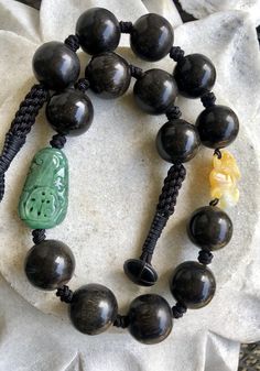 Carved Green Jade Shou Bead Yellow Jade Bat Nut Seed Bead Vintage Necklace Luxury Hand-strung Beaded Necklace With Round Beads, Black Hand-knotted Jewelry With Round Beads, Traditional Hand Knotted Necklaces With Round Beads, Traditional Hand-knotted Necklaces With Round Beads, Traditional Hand Knotted Round Bead Necklaces, Traditional Black Single Strand Necklace, Artisan Hand Knotted Beaded Necklaces With Round Beads, Artisan Hand Knotted Beaded Necklace With Round Beads, Artisan Hand Knotted Beaded Necklaces