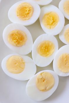 hard boiled eggs on a white tray with red and white towel