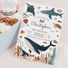 a birthday party with cupcakes, muffins and an ocean themed card