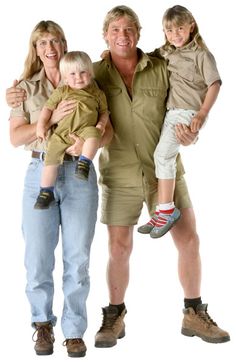 a man, woman and child are posing for a photo together with their arms around each other