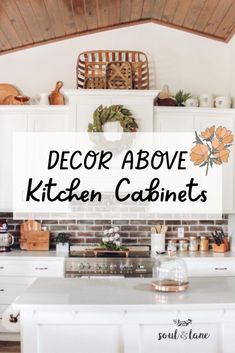 the words decor above kitchen cabinets in front of a brick wall and white cupboards