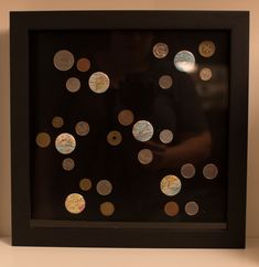 a black frame with lots of coins in it