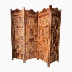 an intricately carved wooden room divider