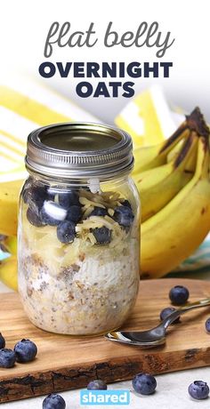 a jar filled with overnight oats sitting on top of a cutting board next to bananas