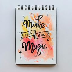 a spiral notebook with the words make your own magic written on it