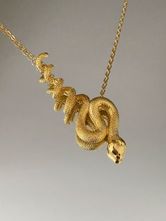 SNAKE NECKLACE This product is brass and gold plated. ♡ The most unique jewelry you can find, perfect gift for you and your loved one. ♡ All of our jewelry is handcrafted with enthusiasm and great care in our workshop. ► HOW TO CARE FOR YOUR JEWELRY * Maintain your jewelry's high shine by avoiding contact with any chemicals such as soap, perfume, lotion, makeup, hair & cleaning products. * Keeping your jewelry in a pouch or a box after using it will prolong the life of your jewelry. * Not recomm Spiritual Brass Snake-shaped Jewelry, Spiritual Brass Jewelry In Snake Shape, Unique Gold Snake Chain Jewelry, Gold Snake-shaped 14k Gold Necklace, Gold Snake Shape 14k Gold Necklace, Symbolic Snake-shaped Brass Jewelry, Unique Gold-tone Jewelry As Gift, Gold-plated Snake Shape Jewelry, Gold Plated Snake Shape Jewelry